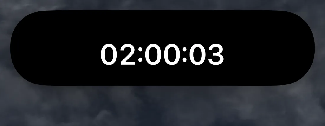 The Dynamic Island expanded by a long press, showing the full hours:minutes:seconds